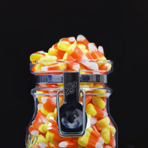realism oil painting of a jar of candy corn with black background - realistic still life by George Ayers