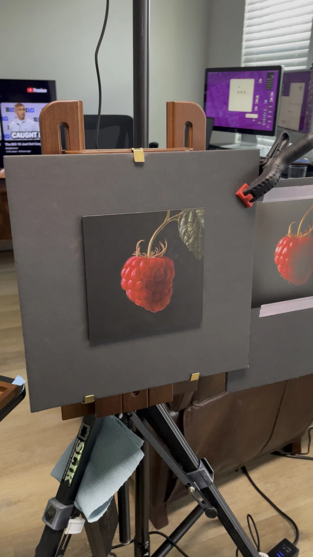 The Raspberry painting in progress on George’s studio easel, with the reference image beside it.